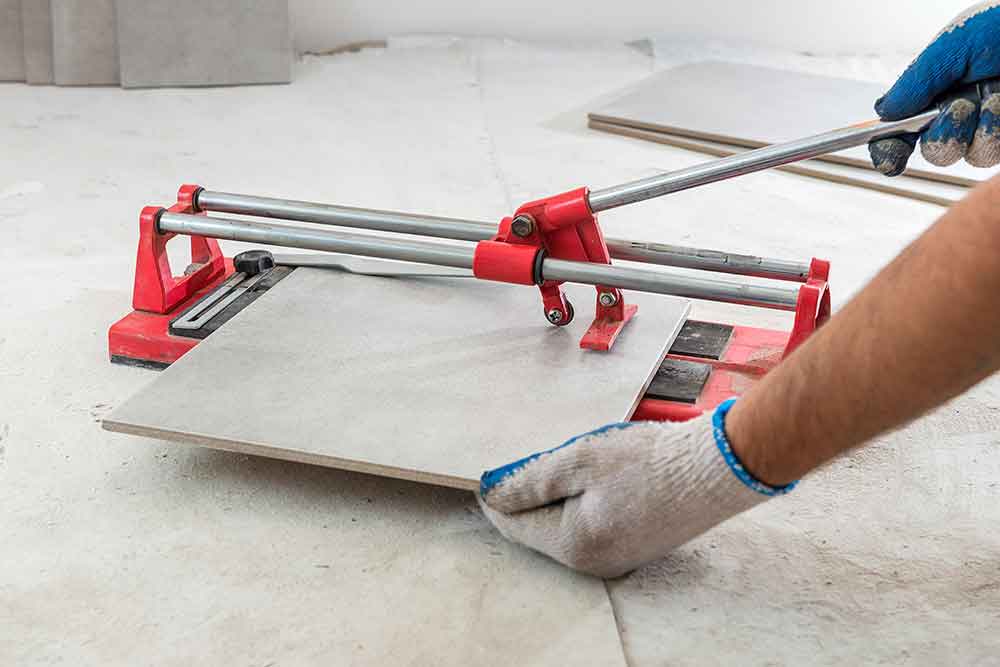 Contractor cutting ceramic tiles