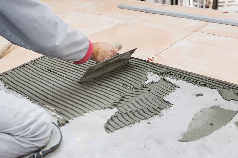 Outdoor tiling contractor installing new tile